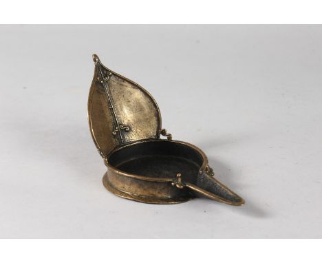 AN UNUSUAL INDIAN BRASS OIL LAMP, 18cm at widest point.