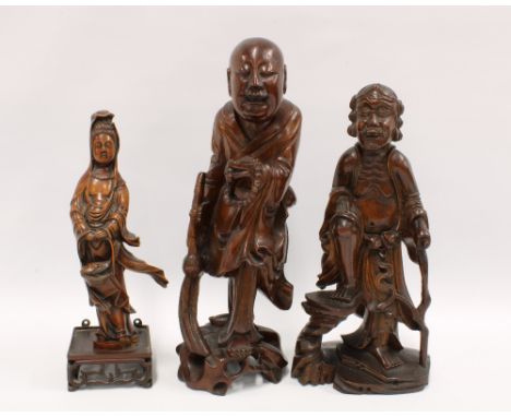 Two fruitwood immortal figures, together with another wooden figure of Guanyin, tallest 34cm (3) 