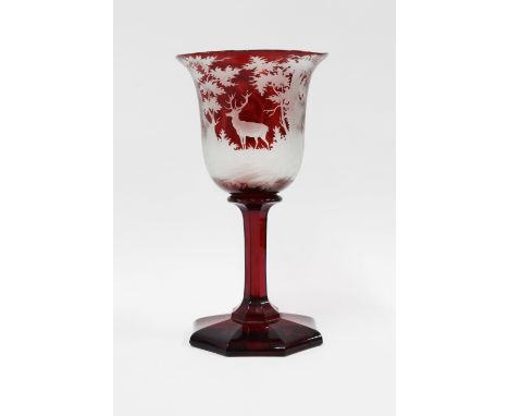 Bohemian ruby etched glass goblet with a stag and forest pattern, with facet stem and octagonal base, 20cm.