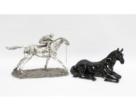Black gloss model of a horse together with another of a jockey and racehorse, 32cm long, (2) 
