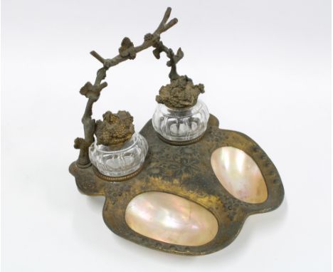 Early 20th century spelter and mother of pearl desk inkstand with two moulded glass inkwells with fruit and vine covers and r