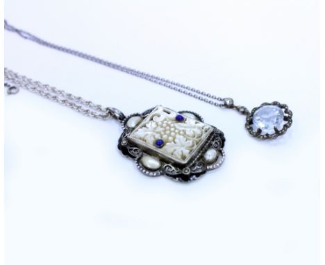 AN ART DECO STYLE WHITE METAL MOTHER OF PEARL PENDANT on a silver chain with black enamel and pearl decoration stamped '936' 