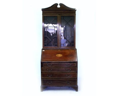 AN EDWARDIAN MAHOGANY BUREAU BOOKCASE with glazed upper section above a fall front with inlaid shell decoration, enclosing a 