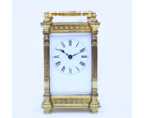 A LATE 19TH / EARLY 20TH CENTURY GILT CASED CARRIAGE CLOCK  with pierced floral design case, with key, 12cm high