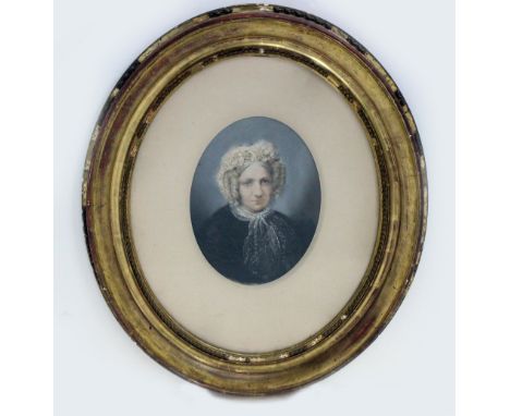 A 19TH CENTURY HEAD AND SHOULDER PORTRAIT  of a lady in a bonnet, pastel, 34cm x 24cm, mounted in a gilded oval frame