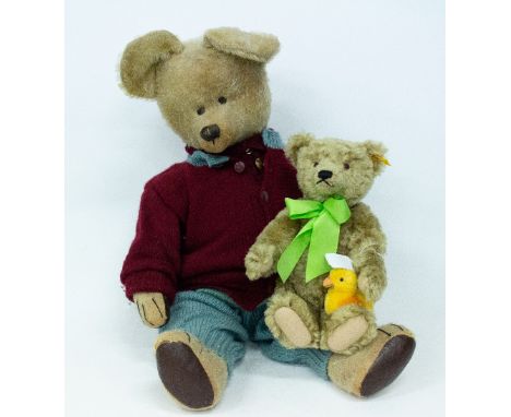 A CONTEMPORARY STEIFF TEDDY BEAR with small chick and a large antique Teddy Bear, possibly Merrythought in knitted clothes, t