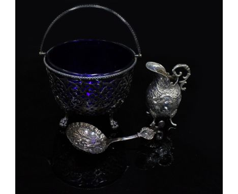 A VICTORIAN SILVER SUGAR BOWL with a blue glass lining and marks for Birmingham 1851 12cm diameter, a silver cream jug and a 