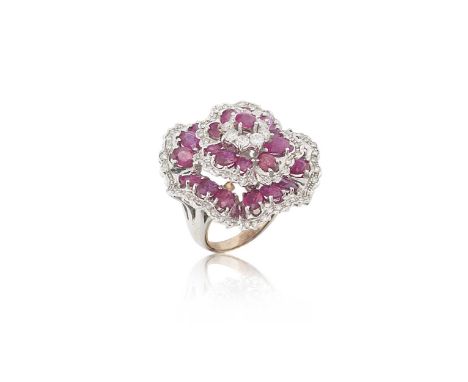 A ruby and diamond set flower cluster ring,  round and oval faceted claw set rubies, and round brilliant cut diamonds, estima