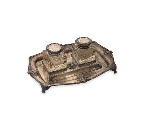 A George V silver desk inkstand,  mark of S. Blanckensee & Son Ltd., Birmingham 1925, of rectangular convex form with shell a