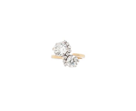 A diamond set crossover style ring, one claw set cushion shaped diamond, approximately 7.95 x 7.3 x 4.6mm, estimated approxim