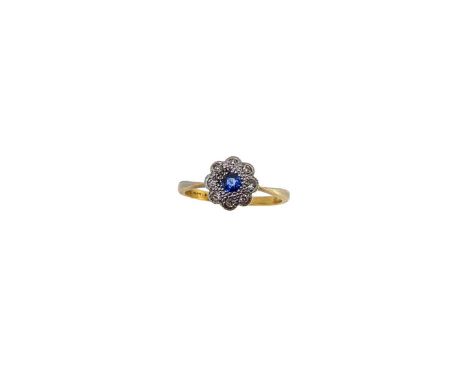 A sapphire and diamond cluster ring, central round faceted sapphire, surrounded by single cut diamonds, head diameter 9.9mm, 