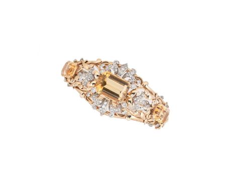 A citrine and diamond hinged bangle,  tapered front section set with a central octagonal citrine, approximately 20 x 15.5mm a