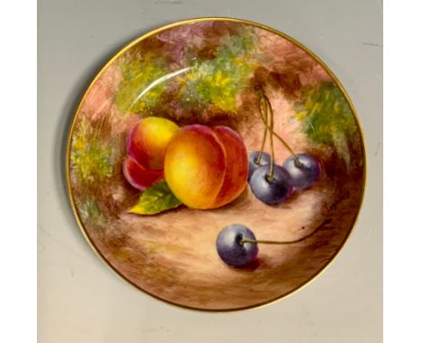 A Royal Worcester circular saucer, painted by Maybury, with ripe peaches and blue berries on a mossy ground, 11cm diam, print