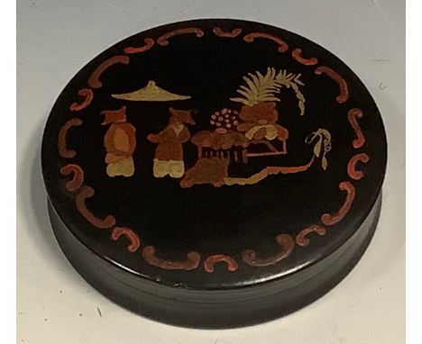 A 19th century japanned papier mache waisted circular table snuff box, the cover decorated in the chinoiserie manner with Chi
