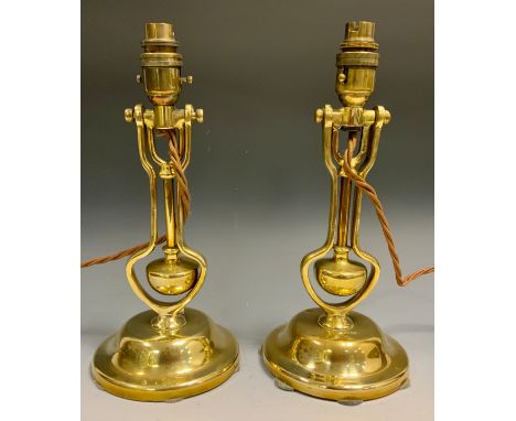 A pair of brass Pullman carriage gimbal lamp, fitted for electricity, 31cm high, late 19th century 