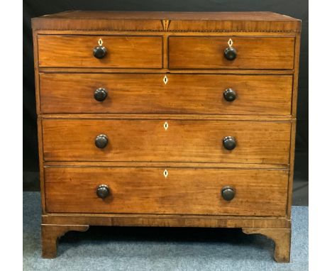 A 19th century mahogany chest, c.1820outlined with ebony barber pole stringing, two short and three long drawers, bracket fee