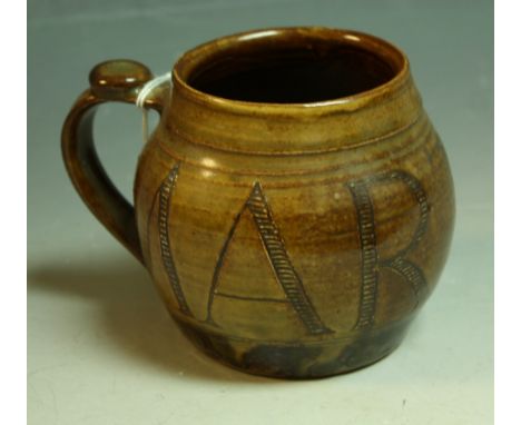 A Wenford Bridge ribbed ovoid mug, by Seth Cardew, slip glazed in mottled brown, sgraffito incised with the name Martha in ta