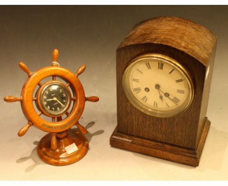 An early 20th century oak mantel clock, arch top, Roman numerals; a novelty Kienzle clock as a ship's wheel; a quantity of cl