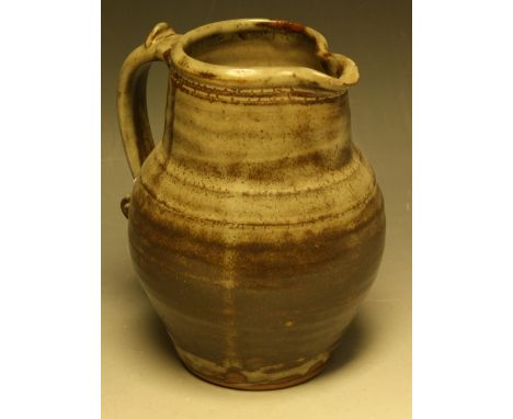 A Leach Pottery, St Ives ribbed ovoid water jug, scroll handle, glazed in shades of brown and grey, 19.5cm high, impressed se