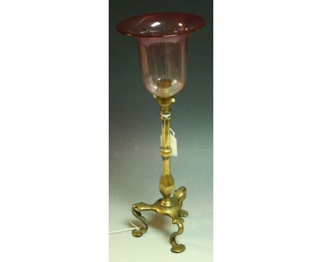 A brass table lamp, attributed to WS Benson, brass column, tripod feet, cranberry glass shade, 42cm high overall