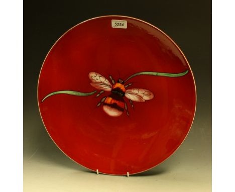 A contemporary Poole charger, decorated with a bee on a red ground, 42cm diam, painted mark, boxed