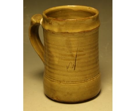 A Wenford Bridge ribbed cylindrical mug, by Danlami Aliyu, slip glazed in mottled olive green, sgraffito incised with repeati
