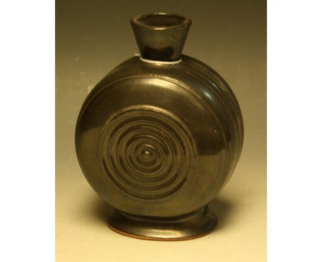 A terracotta moon flask, by Dorothy Kemp, oxidised black glaze, each side incised with a concentric circular motif, 19cm high