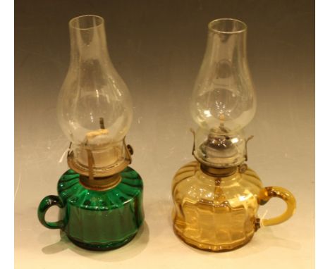 A Victorian coloured glass oil lamp, green glass reservoir, 29cm high; another, smoked glass reservoir, 28cm high (2)