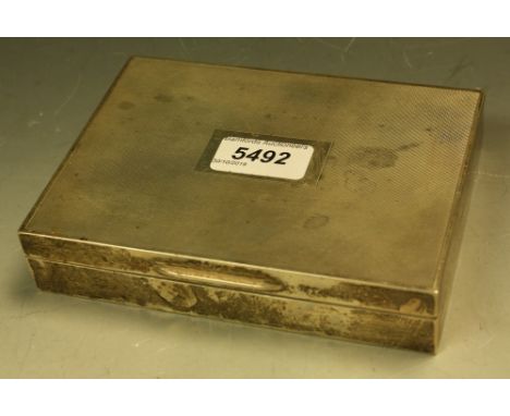 A silver rectangular engine turned cigarette box and cover, vacant central rectangular cartouche, cedar lined, 16cm wide, Bir