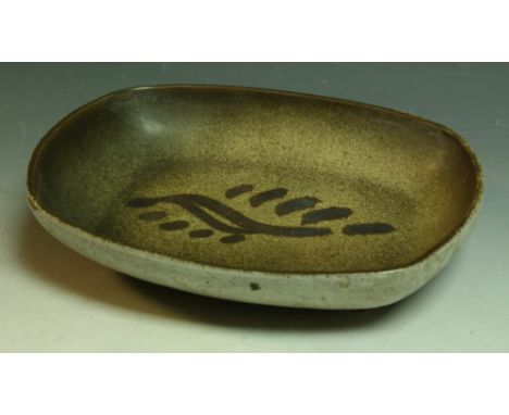 A Sam Haile stoneware rounded rectangular dish, resting on four peg feet, the centre with slip trailed organic form, in mottl