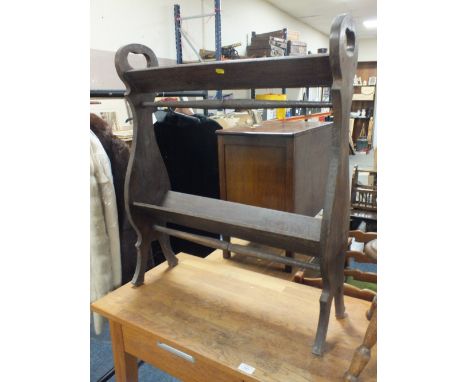 AN OAK 1920'S TWO TIER BOOK TROUGH, with cut-out handles and turned stretcher, H 81.5 cm, W 69 cm