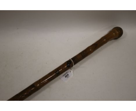 A VINTAGE ORIENTAL BAMBOO WALKING STICK / FISHING ROD, having root handle, the shaft with relief carved decoration and painte