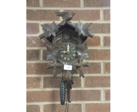 A WALL HANGING VINTAGE WOODEN CUCKOO CLOCK 