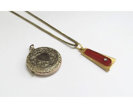 A gold pendant stamped 750 with cornelian panel, 5g hung on a 9ct gold chain 46cm long, 4.4g and a gold plated engraved circu