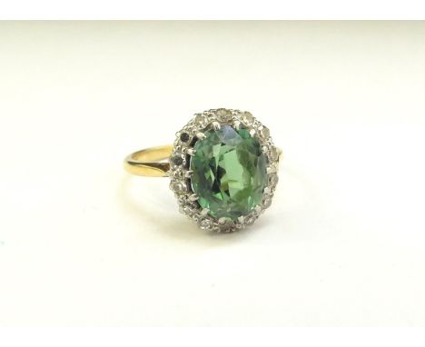 An 18ct/plat green tourmaline and diamond cluster ring, 14mm x 12mm. Size Q/R, 4g 