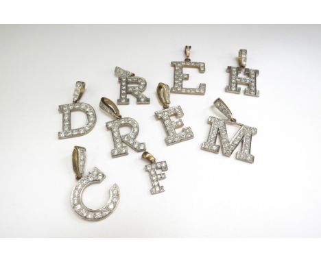Nine 9ct gold charms as letters "M,R,F,C,D,E,H" all set with clear stones 49.4g total 