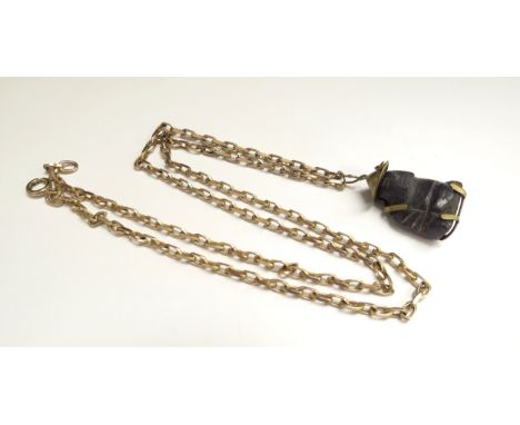 A 9ct gold chain, 54cm long, 11g, hung with a carved pendant of oriental man possibly blue jade in 14k mount 