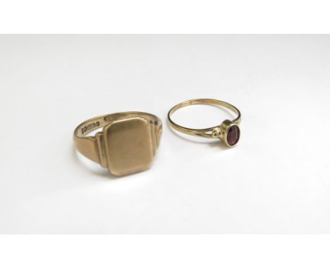 A 9ct gold signet ring, vacant shield. Size R, 4.5g and a gold ring stamped 585 with oval dark orange/brown stone. Size P, 1.