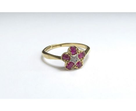 An 18ct gold/platinum set ruby and diamond floral ring. Size P/Q, 2.7g 