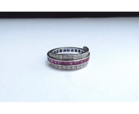 A half sapphire half ruby ring with two rows of hinged diamonds that can be worn wine side, unmarked. Size O, 5.6g 