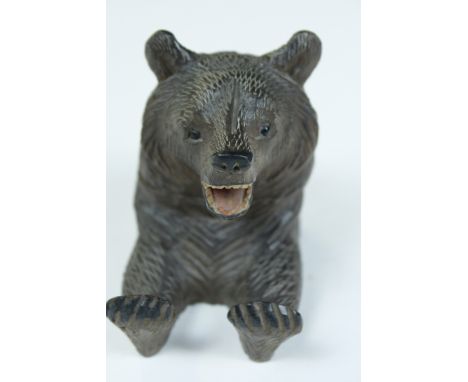 A 20th century black forest inkwell in the form of seated bear, with a hinged lid 