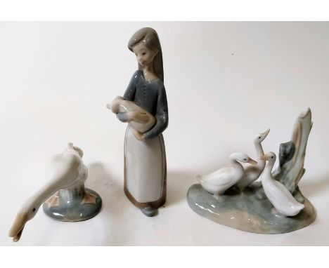 A Lladro figure of a girl holding a piglet, along with a Lladro figure of a goose and a Nao figure of geese