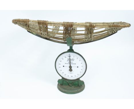 A Boots infant weighing machine, with the original wicker basket and white enamel dial