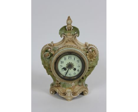 An early 20th century ceramic mantel clock, with an eight movement, elaborate surround, the reverse stamped W&R Austria" "