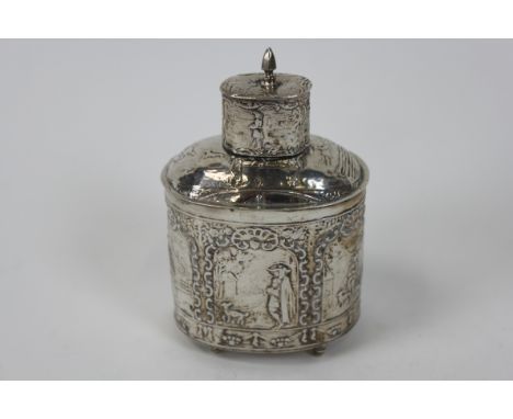 A silver tea caddy, circa 1900, with Dutch control marks and pseudo marks, decorated with figurative panels, pull off cover, 
