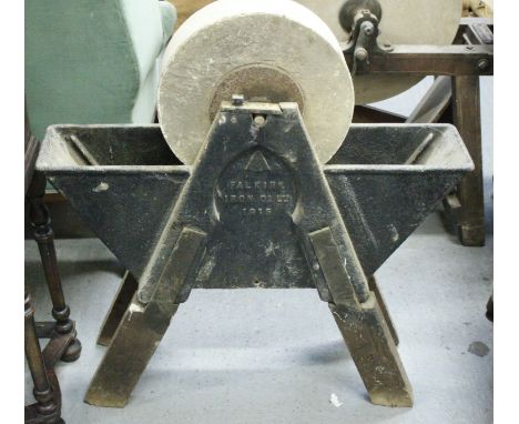 A 20th century knife sharpening stone, on a cast iron base, stamped with the broad arrow, Falkirk Iron Co Ltd 1915""