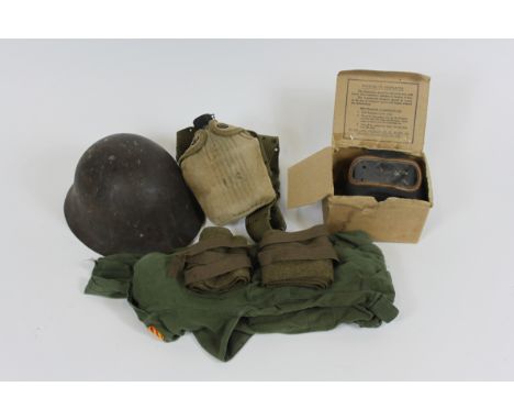 A small collection of military items including a respirator, helmet, U.S. bottle and other items