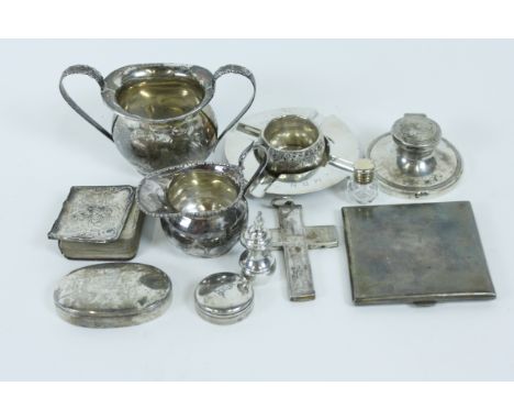 A small silver cream jug; a silver two handled sugar basin; a small silver capstan inkwell; a miniature silver vase and cover