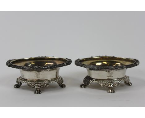 A pair of George III silver salts, in the style of Paul Storr, marks are worn, London 1806, of oval outline, the flared rim w
