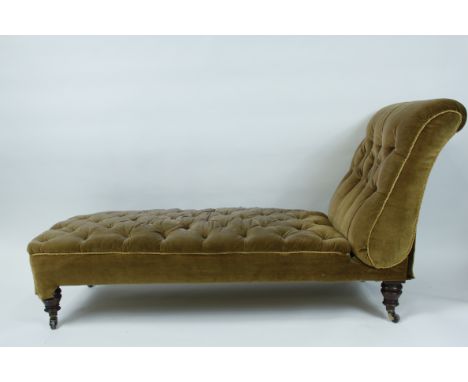 A Victorian day bed, with turned mahogany legs or ceramic casters
